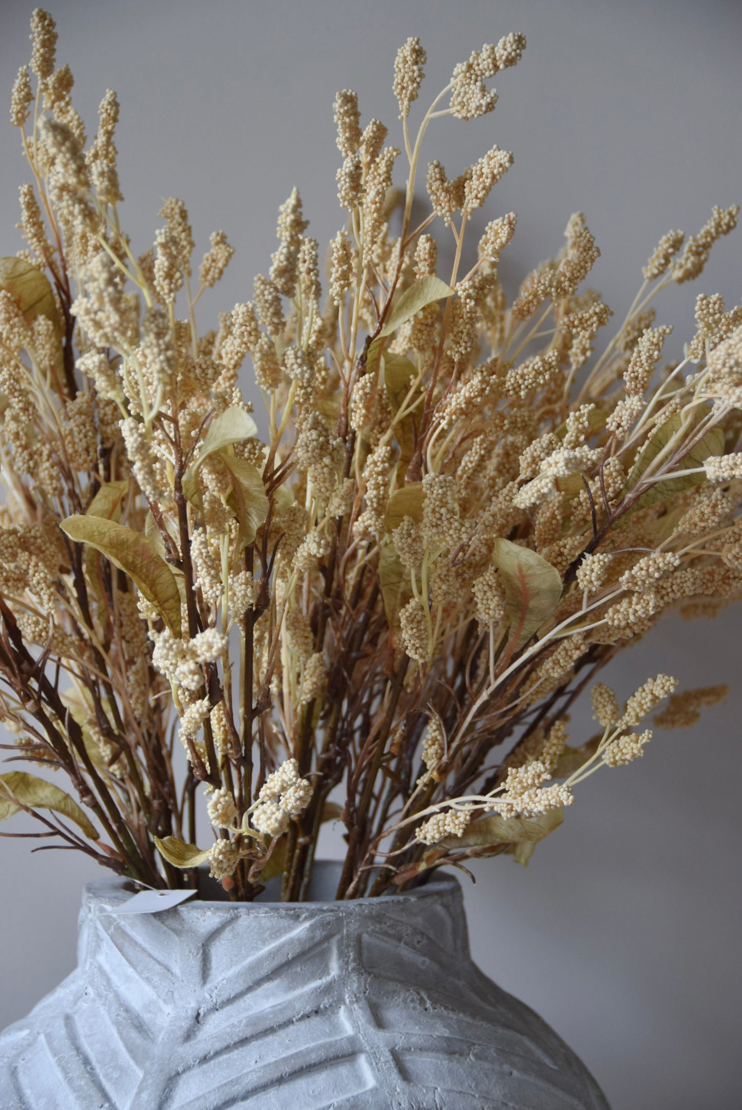 Dried-look grain sorghum spray displayed in a stone chevron style.