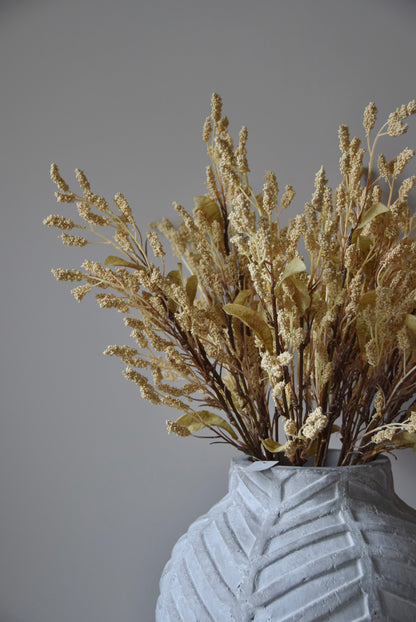 Dried-look grain sorghum spray displayed in a stone chevron style vase.