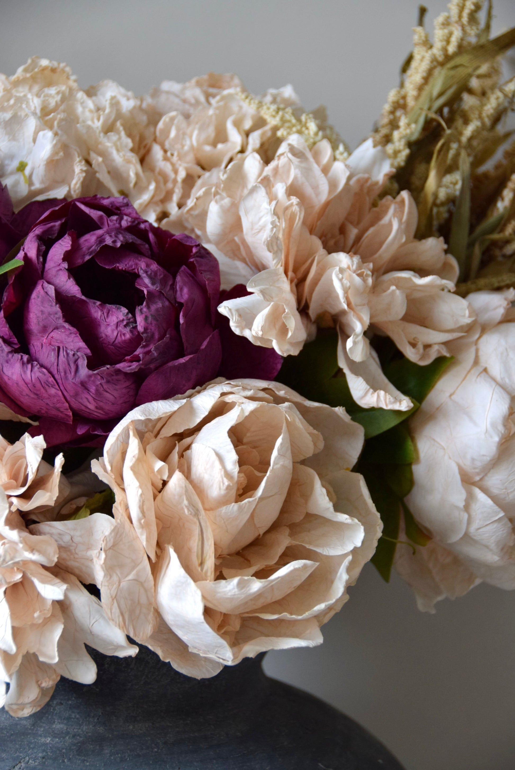 Close-up of a bouquet of flowers with purple and white colors on a neutral background