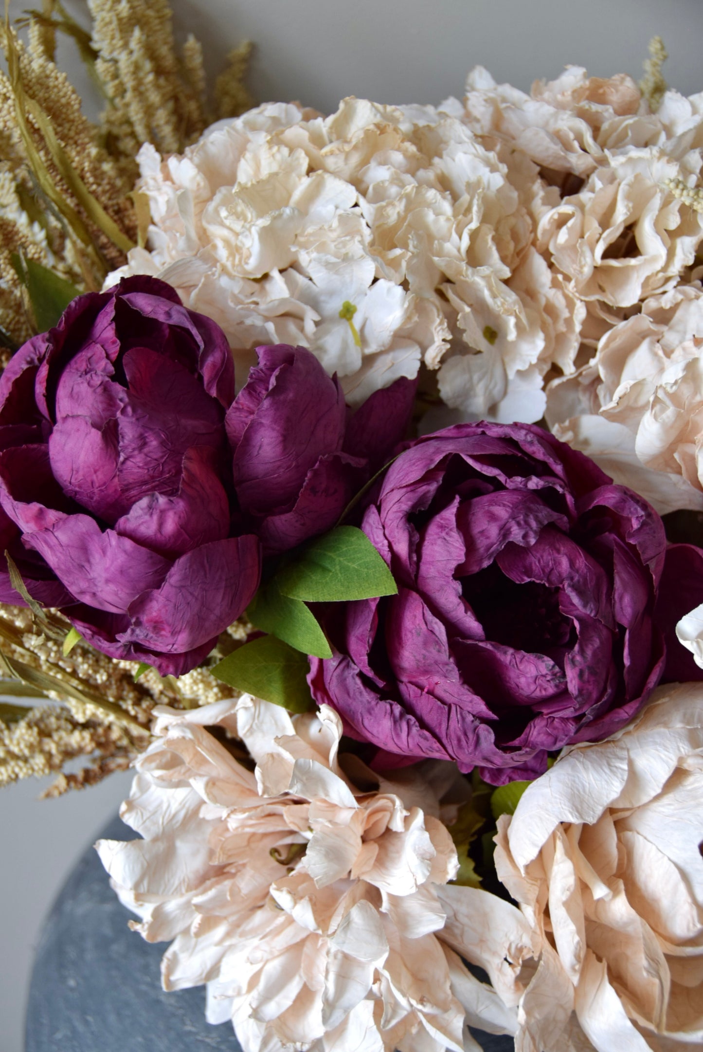 Bouquet of purple and white flowers with a neutral background
