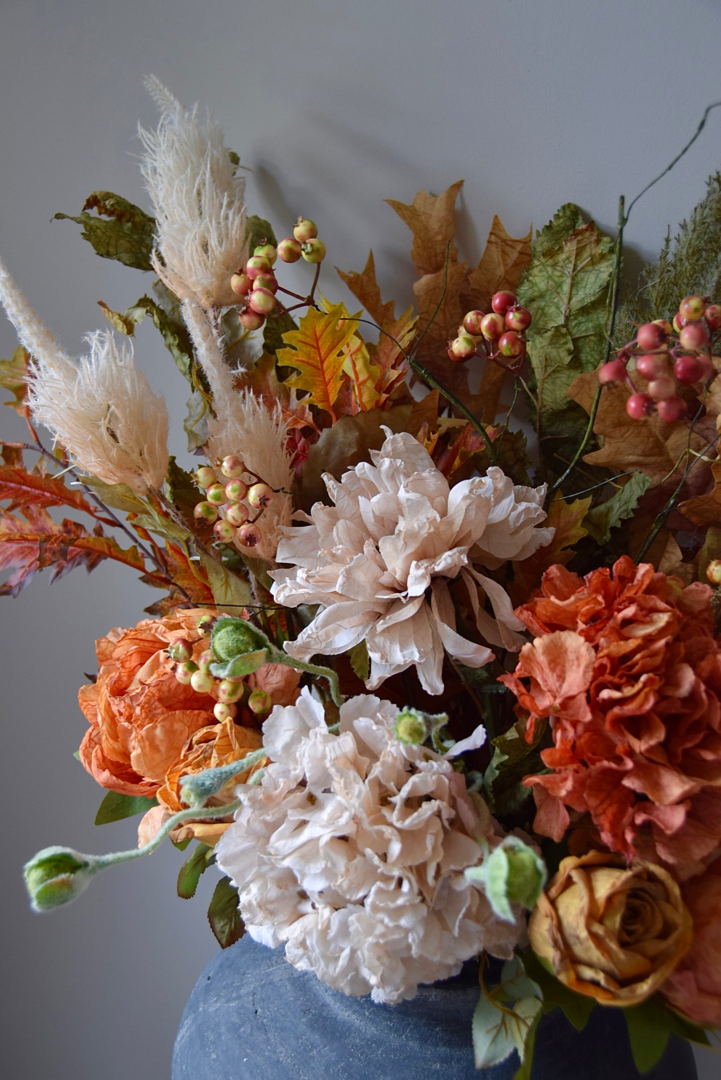 Autumnal flower arrangement with a grey background
