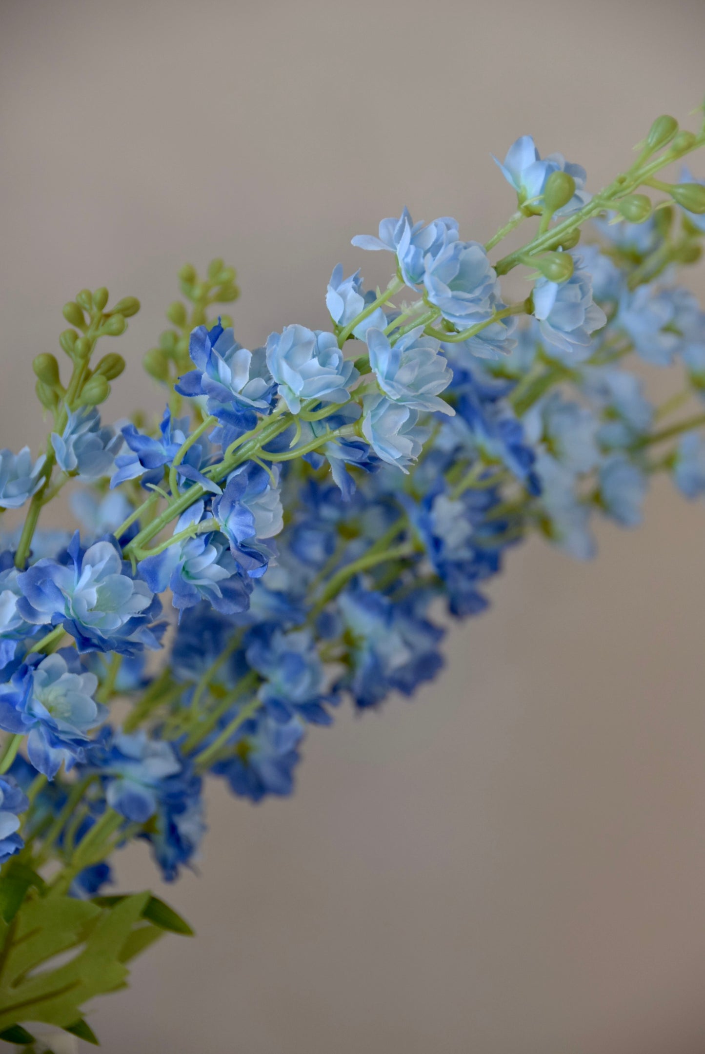 A close up of artificial blue delphinium stems.