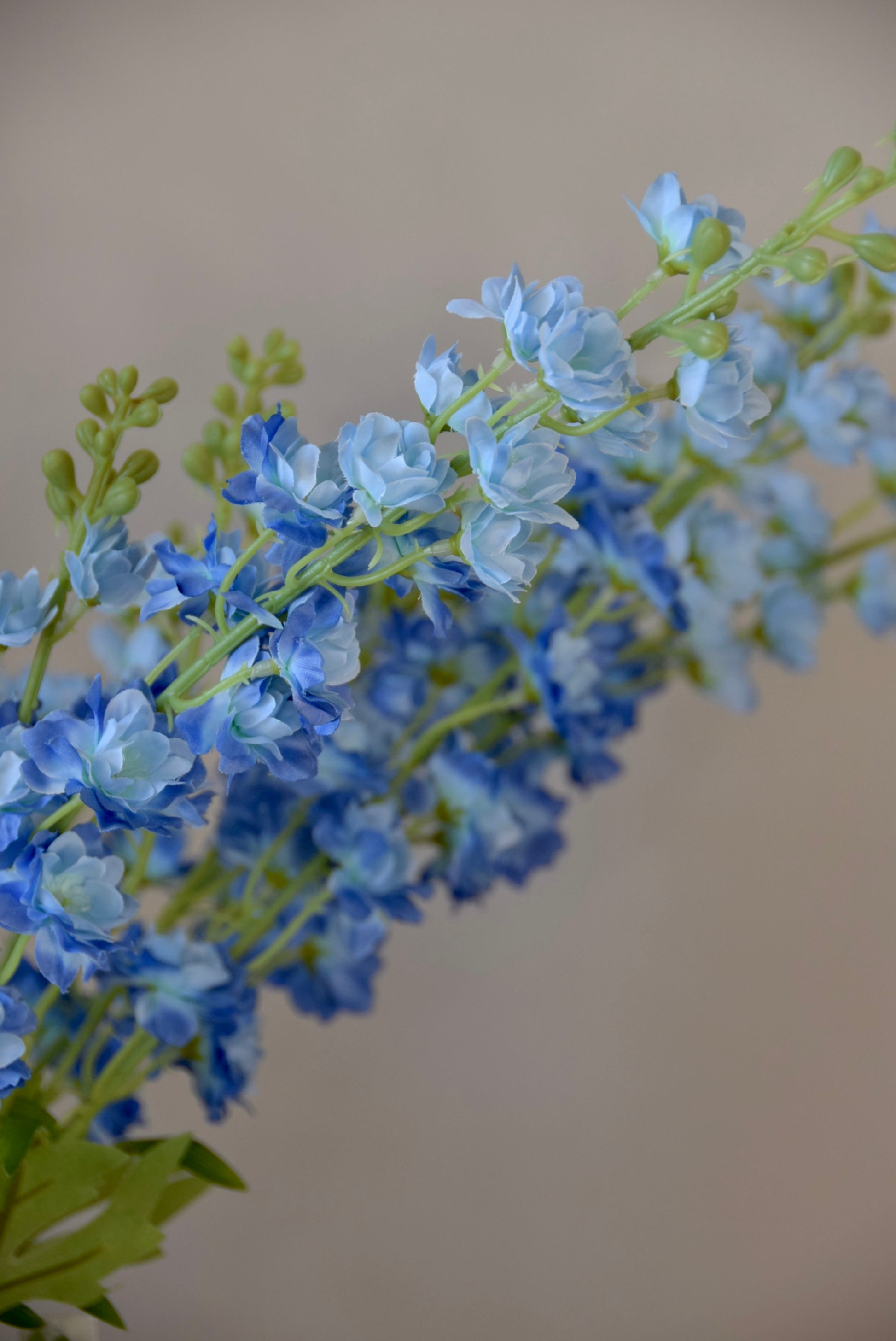 A close up of artificial blue delphinium stems.