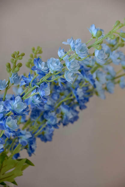 A close up of artificial blue delphinium stems.