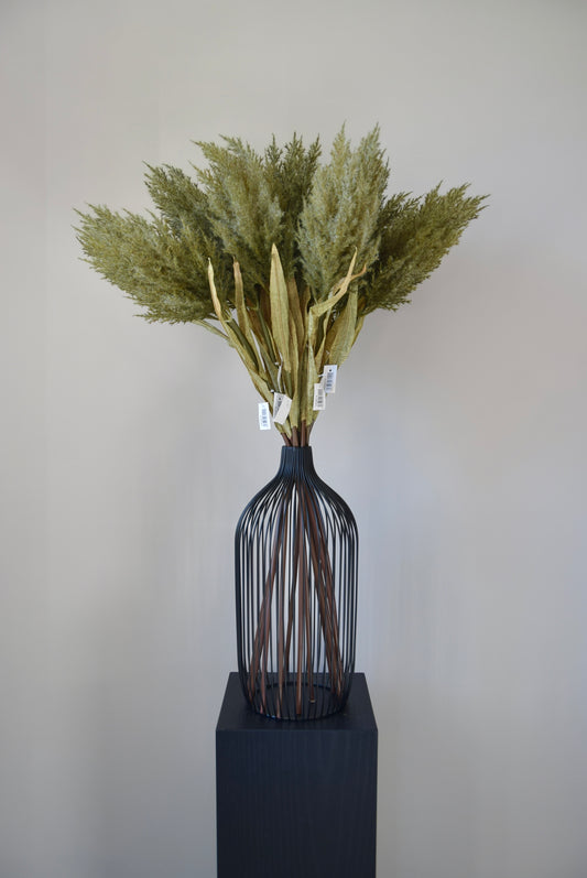 Decorative vase with dried plants on a neutral background