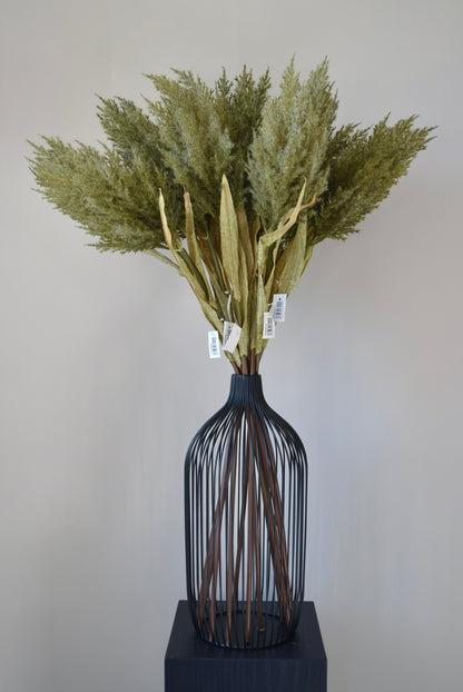 Decorative vase with dried plants on a plain background