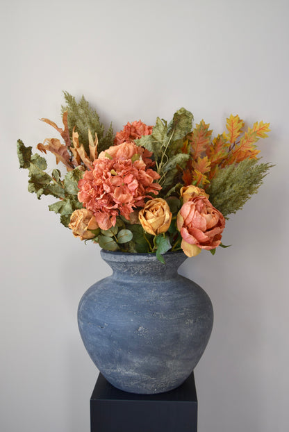 Decorative vase with artificial flowers on a white background