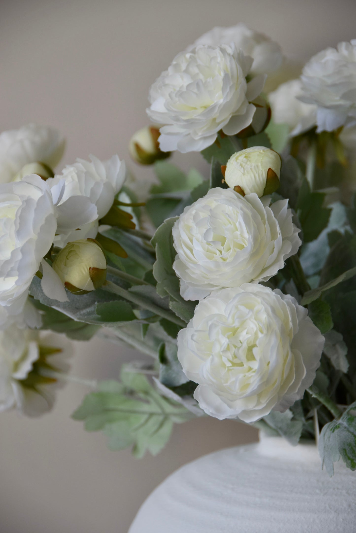 White flowers in a vase against a neutral background